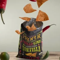 chilli-lime tortilla chips lifestyle image chilli-lime tortilla chips exploding out of the bag